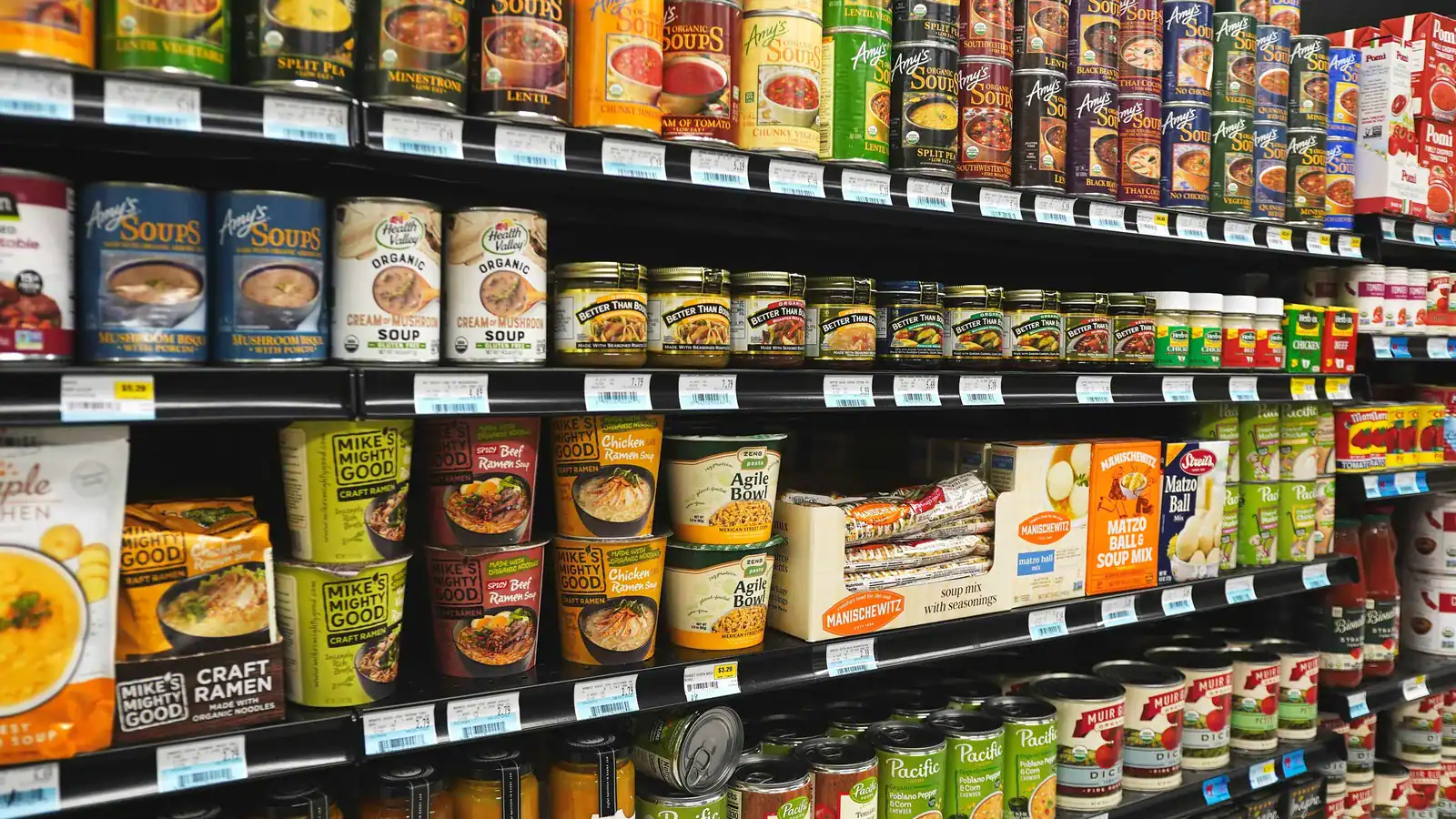 Grocery store shelves stocked with canned and packaged food