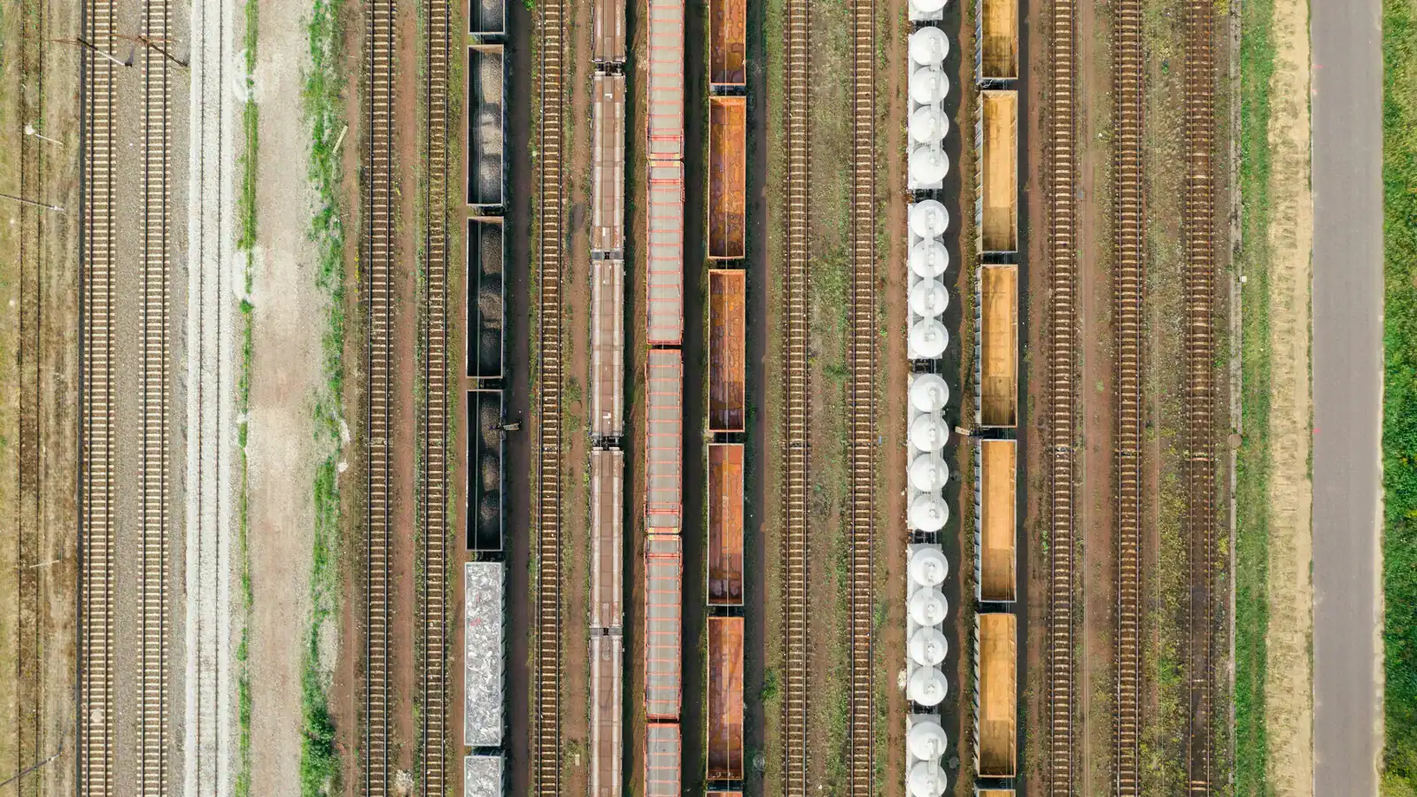 Aerial view of a rail yard with parallel tracks and freight wagons