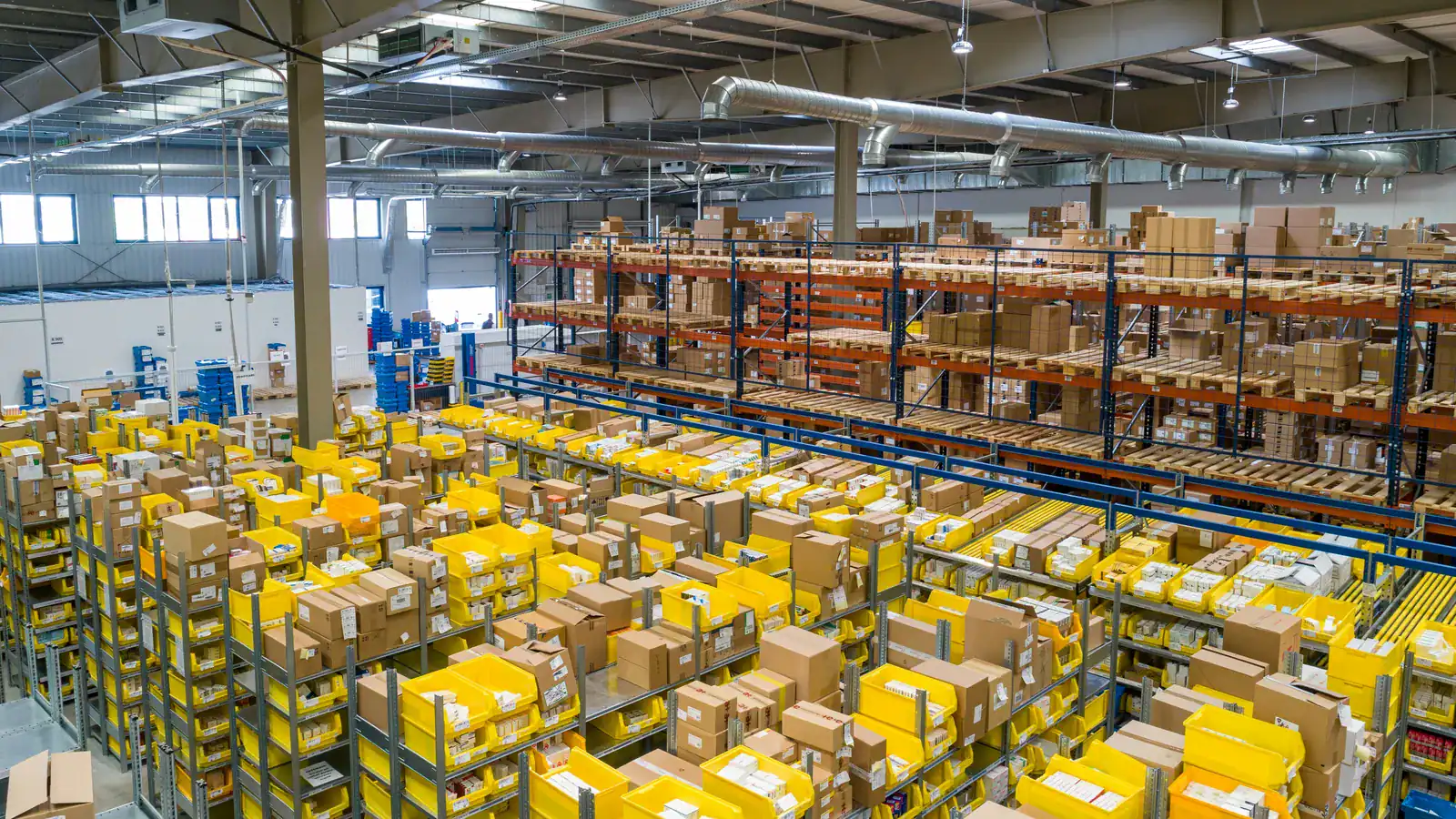 Warehouse floor filled with stacked yellow and white crates