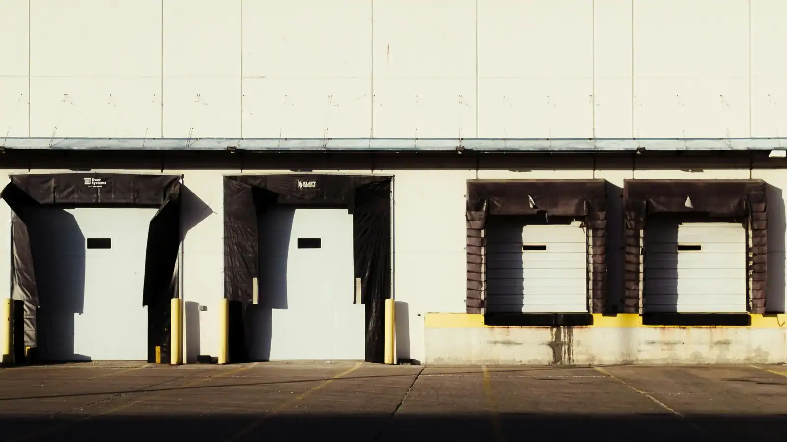 Row of truck loading dock doors on a warehouse building