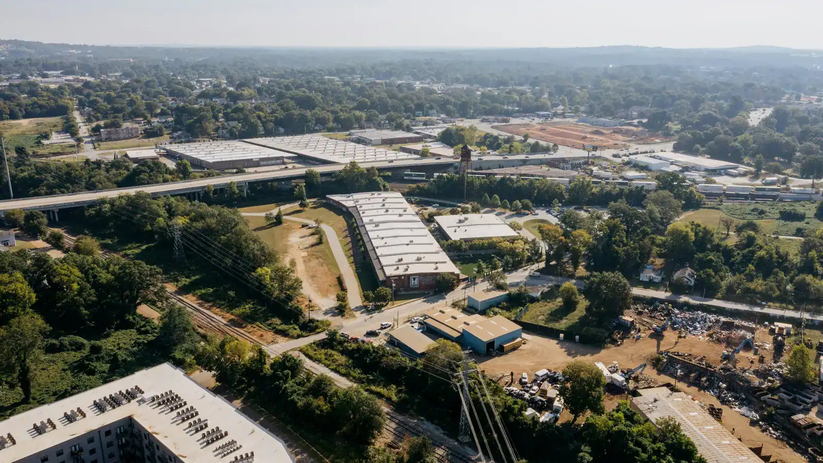 Aerial view of an industrial park beside a highway overpass