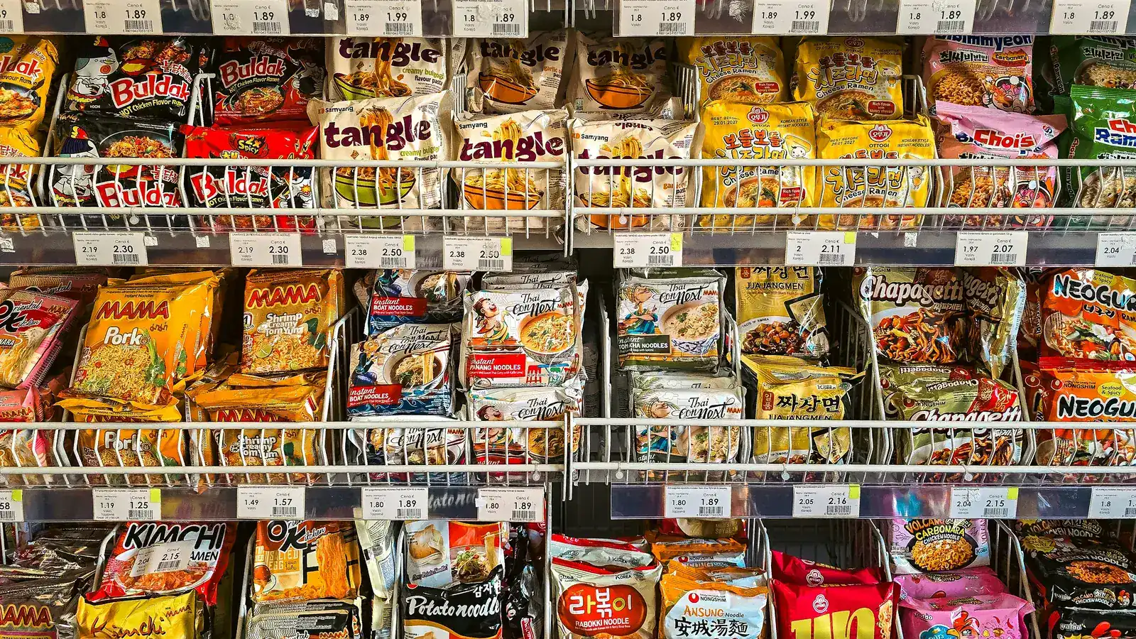 Grocery shelves stocked with instant noodle packages